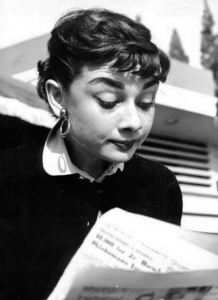 Audrey Hepburn reading a newspaper